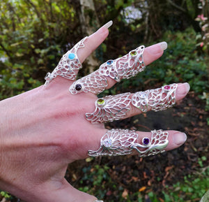 The Gossamer Statement Rings with gemstone settings displayed on fingers.