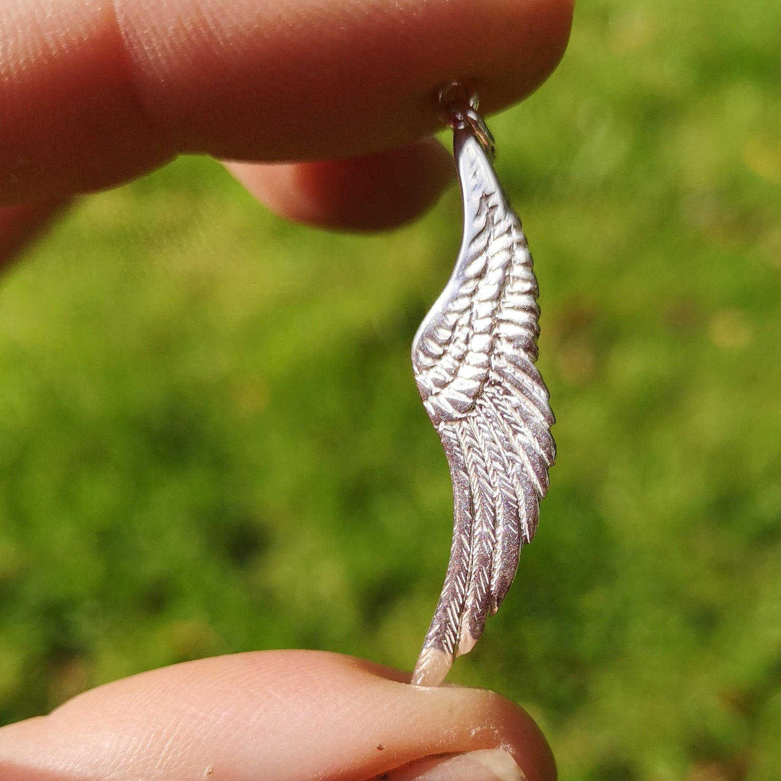 Angels whisper wing charm made of sterling silver, handmade by Irish jewellery designer Elena Brennan in Cavan, Ireland.