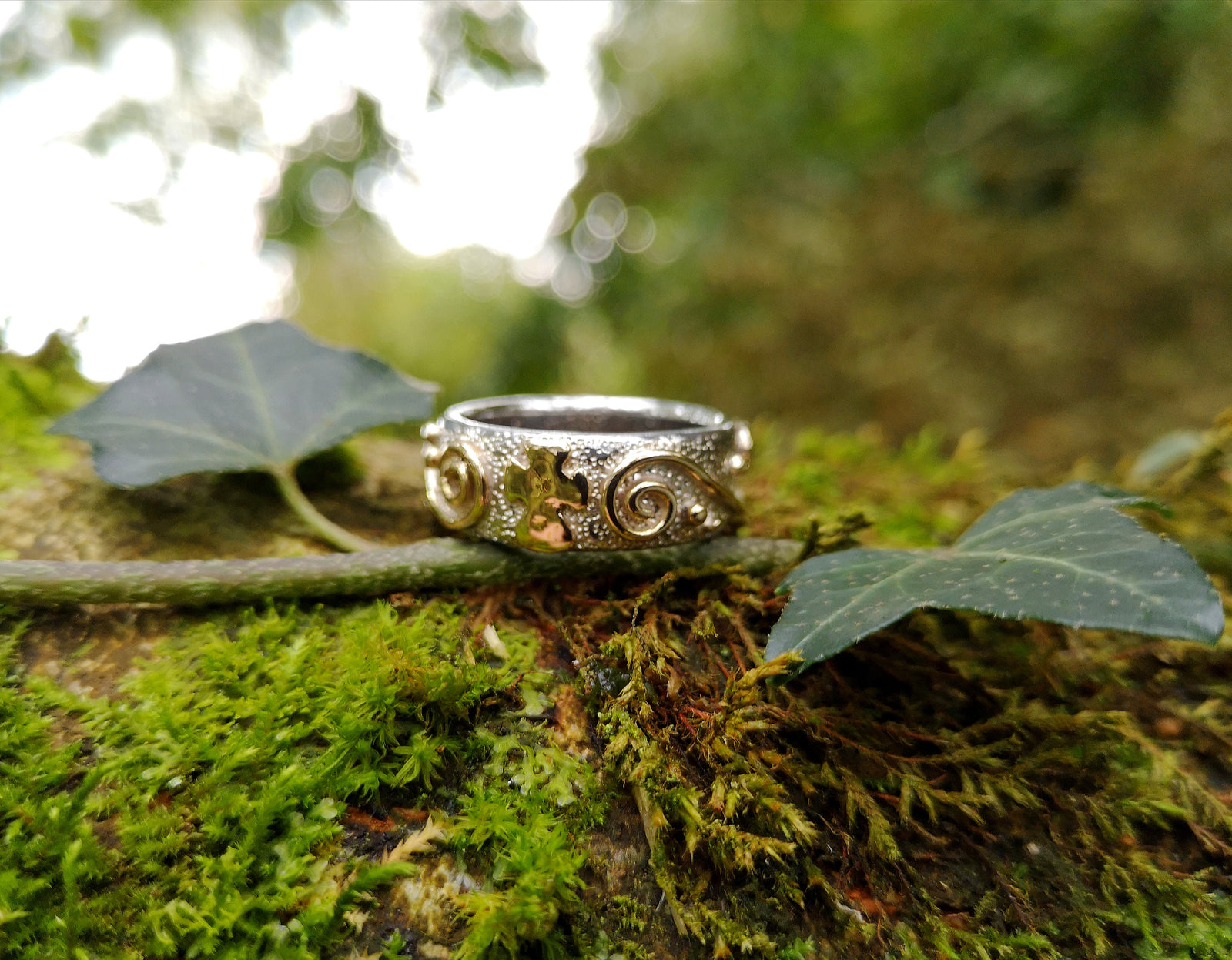 Bespoke silver ring with bumps and gold spirals by Elena Brennan