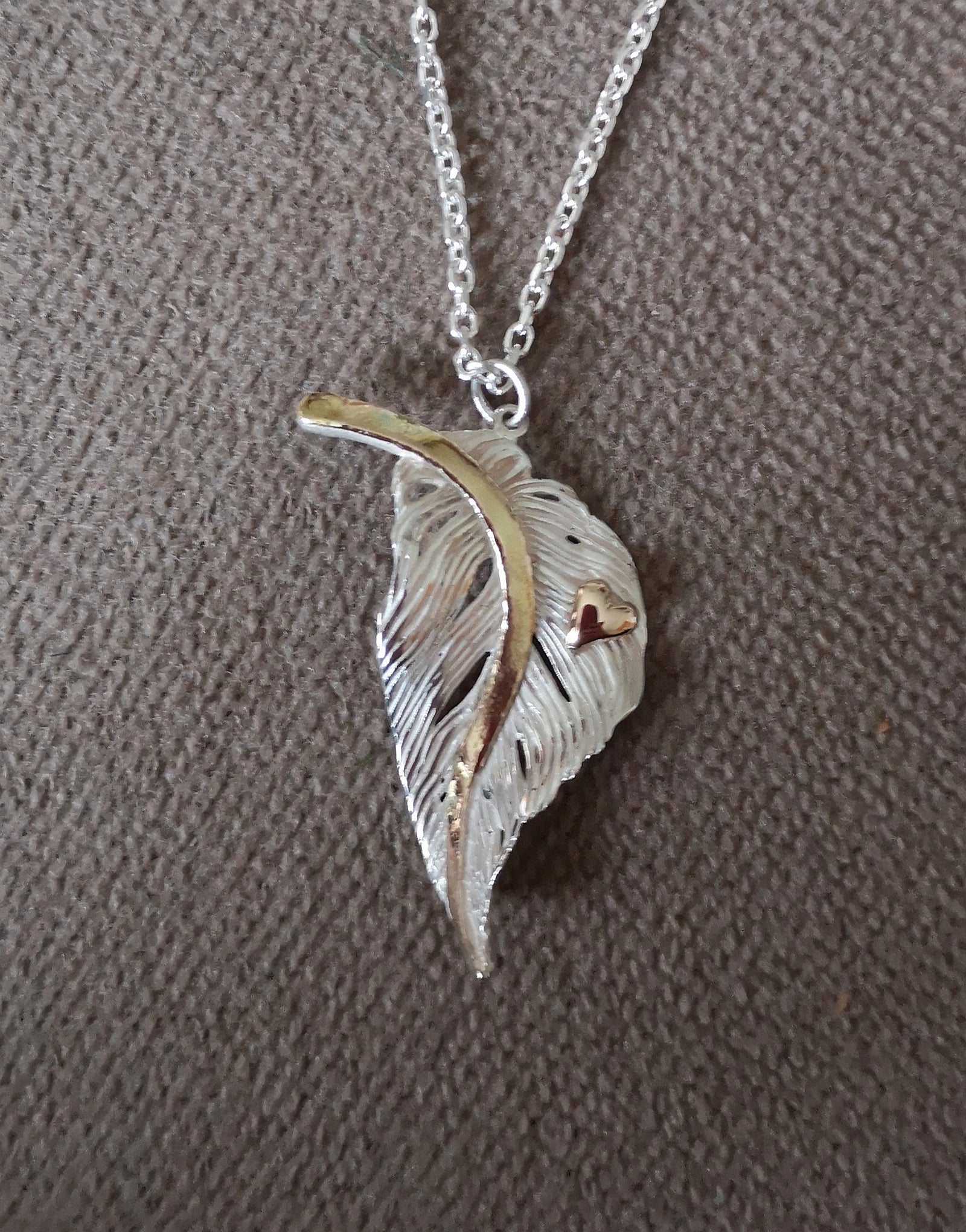 Bespoke gold and silver feather with heart decoration, by Irish jewellery designer Elena Brennan