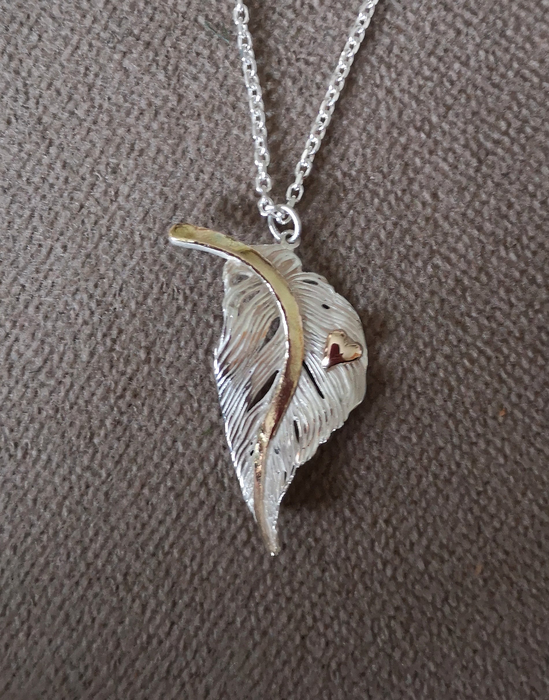 Bespoke gold and silver feather with heart decoration, by Irish jewellery designer Elena Brennan