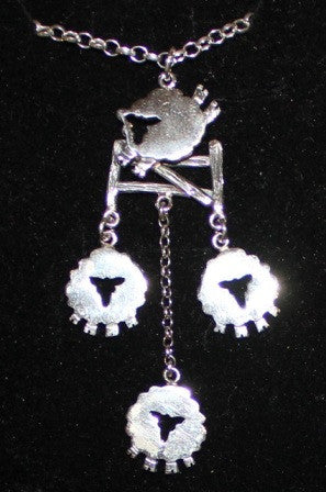 Sheep jumping over fence and three sheep pendant made of sterling silver, handmade by Irish jewellery designer Elena Brennan in Cavan, Ireland